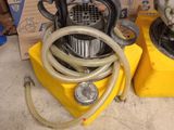 two air compressors sitting next to each other on the floor