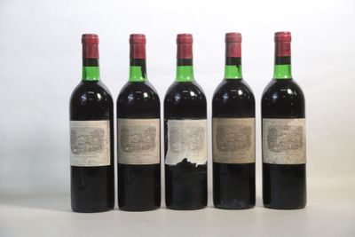 four bottles of wine are lined up on a table