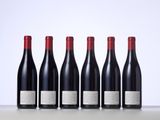 six bottles of red wine lined up in a row