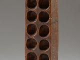 an image of a sculpture of a woman holding a wine rack