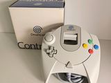 a video game controller sitting on a table next to a box
