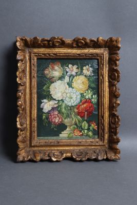 painting of flowers in a gold frame on a gray background