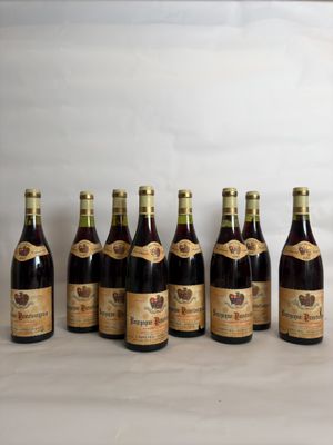 six bottles of wine lined up in a row on a table