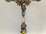 a silver cross with a gold cross on top of it