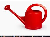 un arrosoir rouge posé sur une surface blanche