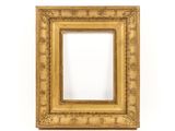 an antique gold frame with a decorative pattern on the edges