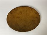brass plate on white surface with brown background