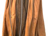 brown leather jacket on a mannequin stand against a white wall