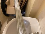 a person standing in a room with a sink and a tub