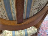 a wooden chair with a blue and white striped seat