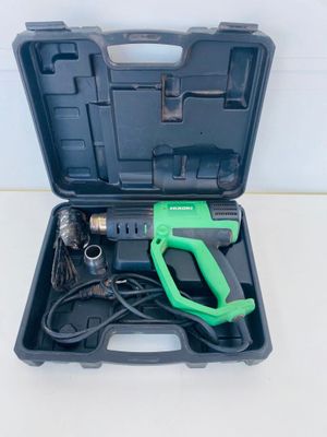 an image of a green and black tool in a black case
