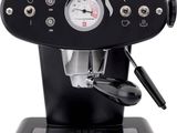 the coffee machine is black and has a clock on it