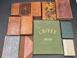 many old books sitting on a table with a book cover