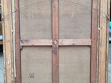 an old wooden cabinet with a glass door on it
