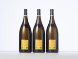 three bottles of wine sitting on top of a table next to each other
