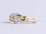 a gold ring with a heart shaped diamond on it
