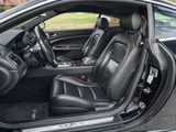 the interior of a car with the door open and the driver ' s seat down