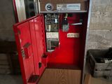 a coca cola machine in the corner of a room