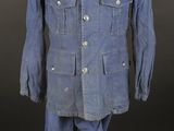 an old blue uniform on a mannequin stand on a black background