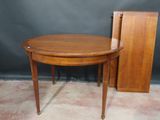 a wooden table with a drawer and a chair next to it