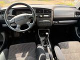 a dashboard of a car with a steering wheel and dashboard controls