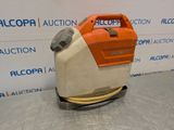 a close up of a floor scruber on a table in front of a wall