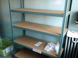 shelves in a room with a radiator and a radiator in the corner