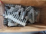 a box full of screws and nails on a shelf