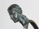 statue of a man with a long hair and a brown shirt