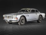 an image of a classic car on a black and white checkered floor