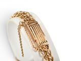 an image of a gold bracelet with a chain around it