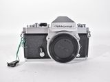 a black and white photo of a camera with a green cord