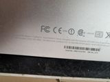 the back of a laptop computer with a sticker on it ' s side