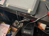 a laptop computer sitting on top of a desk in a messy office