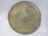 a gold plate on a white surface with a white background