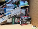 a cardboard box full of electronics and other items