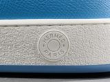 a close up of a pair of blue sneakers with white soles