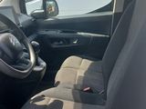 the interior of a small van with the front seats folded down