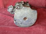 a metal object that is sitting on a red cloth