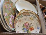 a box full of plates and bowls sitting on the floor
