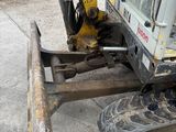 a small excavator that is sitting on the ground