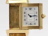 an image of a close up of a wrist watch on a clear surface