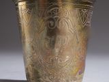 a silver cup that is sitting on a table