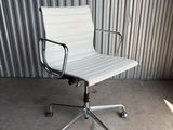 an image of a white office chair sitting in front of a corrugated wall