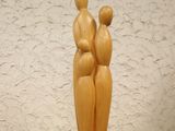 a wooden sculpture of two people standing on a table