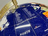 a blue and gold globe with the names of the countries on it