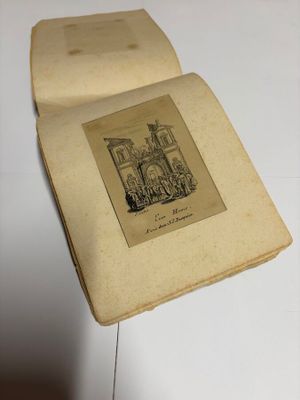 an old book with a drawing on it sitting on top of a table