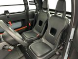 two seats in the back of a car with a steering wheel