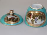 two blue and gold vases sitting on a white table