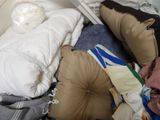 a bed with pillows and pillows on it in a room